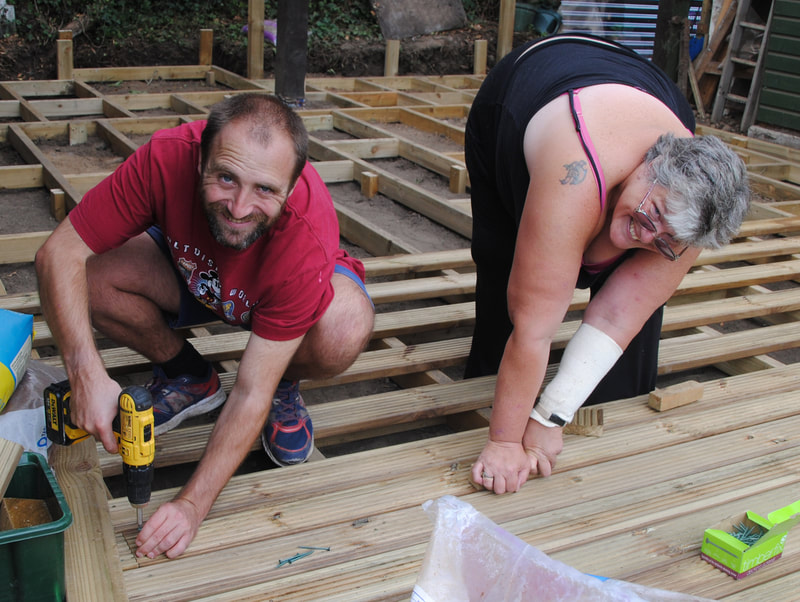 Man and a lady building decking area