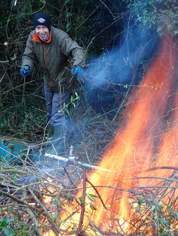 Man building a bonfire by clearing